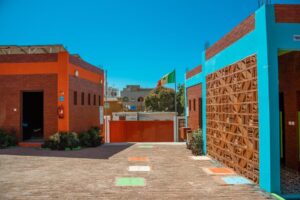 A colorful courtyard with a gate and a flag.