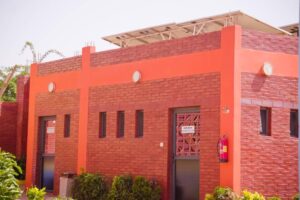 A red brick building with a large sun roof.