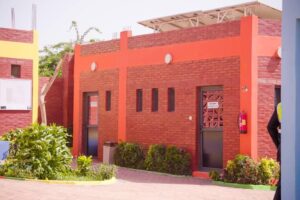 A red building with a large window and a door.