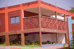 A building with a red roof and yellow tables