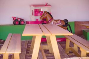 A wooden table with a toy horse on top of it.