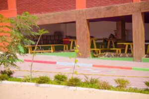 A view of some tables and benches outside.