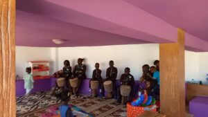 A group of people sitting in front of a wall.