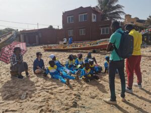 A group of people sitting on the beach