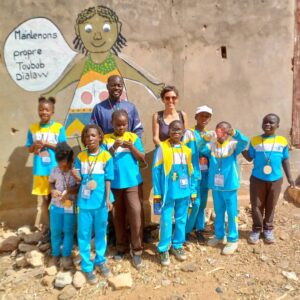 A group of children standing in front of a wall.
