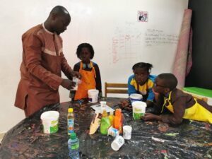 A man and some kids sitting at a table