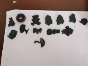 A white table with some black plastic toys
