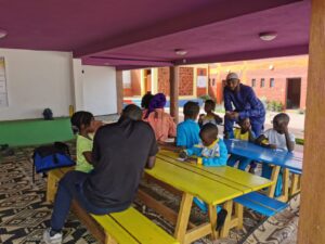 A group of people sitting at picnic tables.