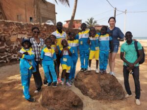 A group of people standing next to rocks.