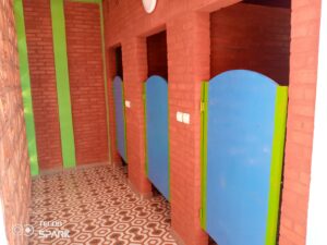 A bathroom with three stalls and two walls.