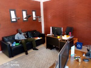 A man sitting on the couch in front of a computer.