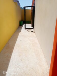 A hallway with a door open and a window.
