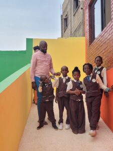 A group of kids standing in front of a wall.