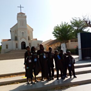 A group of people standing in front of a church.