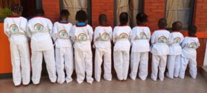 A group of young children in white uniforms.