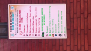 A sign on the side of a building with various signs.