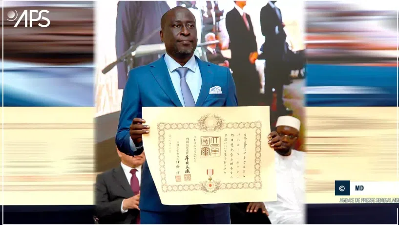 A man in a suit holding up a certificate.