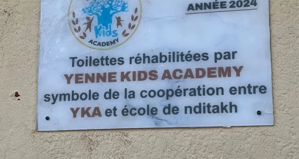 A plaque on the wall of a building.